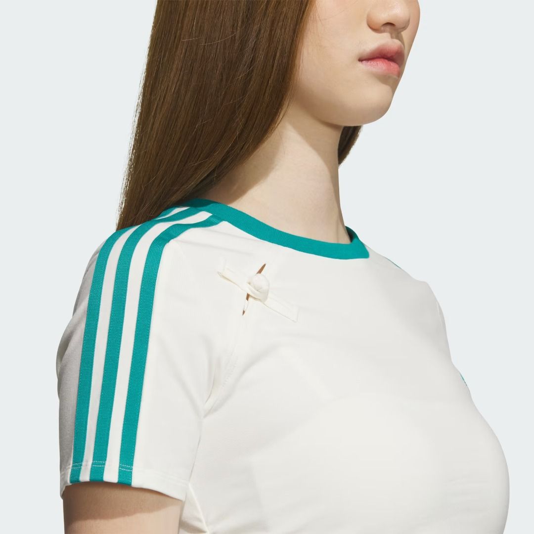 Adidas Classic Chinese New Year Tee (Category: Shirts) located in Makati City. Submitted by pulsepop.ph (Listing ID 1395082720, Image 2). Description: XS-XL Made from soft single jersey fabric, this adidas Chinese New Year t-shirt is a classic, comfortable style. The contrast-colour 3-Stripes, Trefoil and crewneck collar give it a clean, slightly retro vibe. The slim fit hugs your body for a sleek look. Colour: Off White / Pure Teal.
