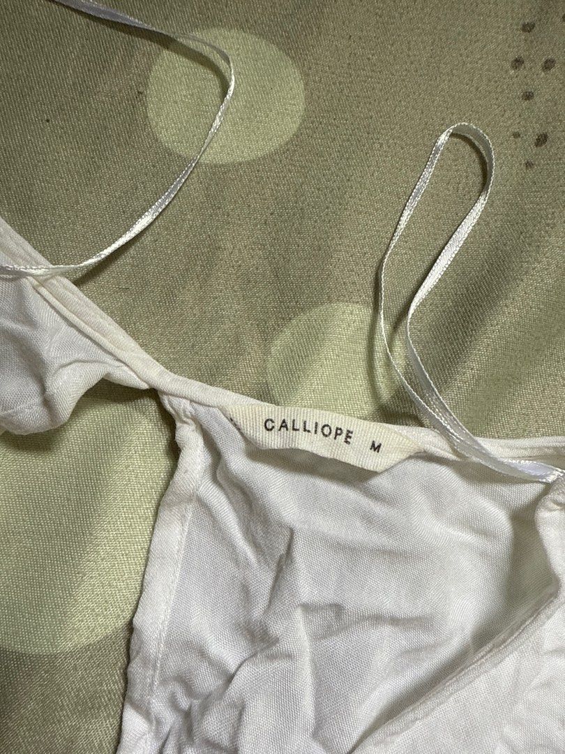 Calliope White Top (Category: Sleeveless) located in Mandaluyong City. Submitted by quickriver.c73050 (Listing ID 1395017037, Image 2). Description: - Calliope white top - Size: M - Design: Tie-up back - Neckline: V-neck - Sleeves: Short, flared.