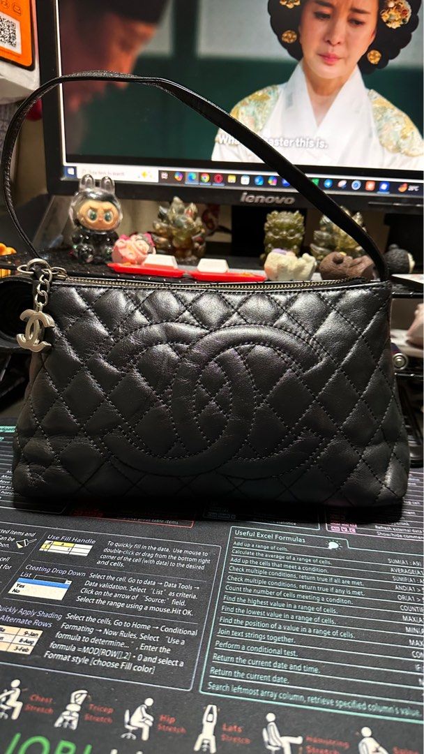 Chanel Quilted Leather Clutch Bag (Category: Luxury Bags & Wallets) located in Taytay. Submitted by jp4_fashion_hub (Listing ID 1395114843, Image 1). Description: - Black quilted leather clutch bag - Detachable strap included - Gold-toned zipper - Silver Chanel logo charm - Black fabric interior with Chanel logo pattern - Diamond pattern.
