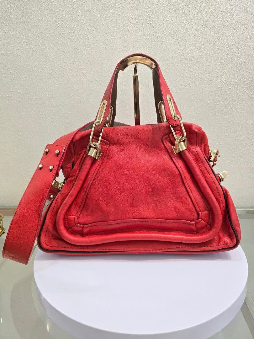 Chloe Paraty Leather Handbag (Category: Luxury Bags & Wallets) located in Davao. Submitted by luxben (Listing ID 1395148956, Image 1). Description: - Authentic Chloe Paraty handbag - Red leather - Gold-tone hardware - Detachable shoulder strap - Main compartment and small pocket - Top handle - Zip closure - Made in Italy - Chloe logo inside.