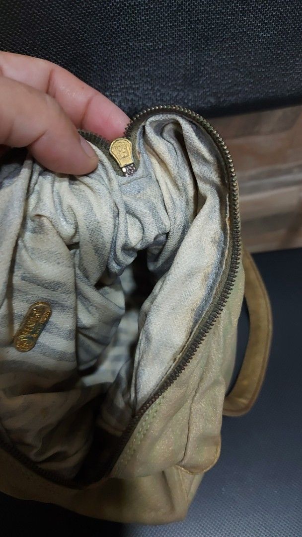 Fendi Tote Bag (Category: Luxury Bags & Wallets) located in Quezon City. Submitted by threetwotwo2ndaccount (Listing ID 1394975926, Image 3). Description: - Authentic Fendi tote bag - Beige exterior with brown handles - Secure zip closure - Stylish striped interior lining - Gold-colored zipper pull - Iconic round logo patch - Made from durable material issue: medyo malagkit ung handle as is .