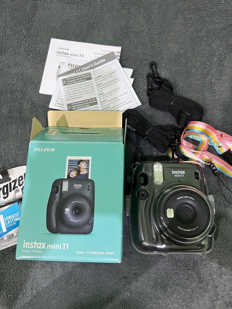 Fujifilm Instax Mini 11 Charcoal Gray (Category: Cameras) located in Quezon City. Submitted by beafinds (Listing ID 1395126411, Image 1). Description: - Fujifilm Instax Mini 11 instant camera (Charcoal Gray) - Includes original box and user's guide - Comes with a protective clear case - Features a camera strap - Includes a set of Energizer AA batteries - Ready to capture instant photos! FREE SHIPPING.