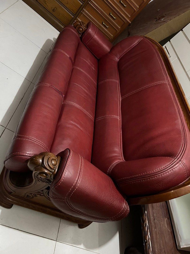Genuine Red Leather Sofa with Wooden Frame (Category: Sofas) located in Manila. Submitted by Hezcki (Listing ID 1394998298, Image 3). Description: - Classic red leather 3-seater sofa - Features a wooden frame and armrests - Well-maintained leather - Comfortable and sophisticated design - Perfect for living rooms.