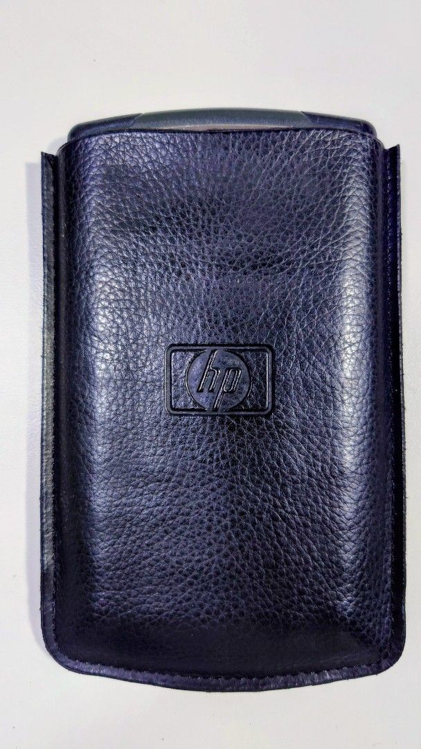 HP 10BII Financial Calculator (Category: Office & Business Technology) located in Makati City. Submitted by ppomidyar (Listing ID 1395131878, Image 2). Description: - HP 10BII financial calculator - Includes protective case - Features financial function keys - Color: Black with silver accents - Comes with a black leather case with HP logo.