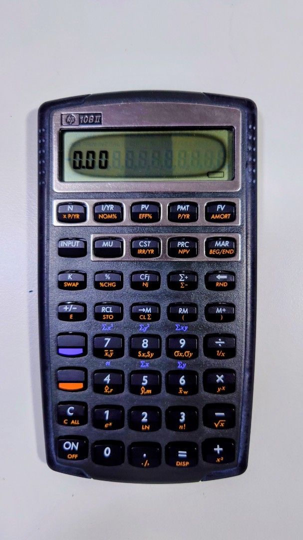 HP 10BII Financial Calculator (Category: Office & Business Technology) located in Makati City. Submitted by ppomidyar (Listing ID 1395131878, Image 1). Description: - HP 10BII financial calculator - Includes protective case - Features financial function keys - Color: Black with silver accents - Comes with a black leather case with HP logo.