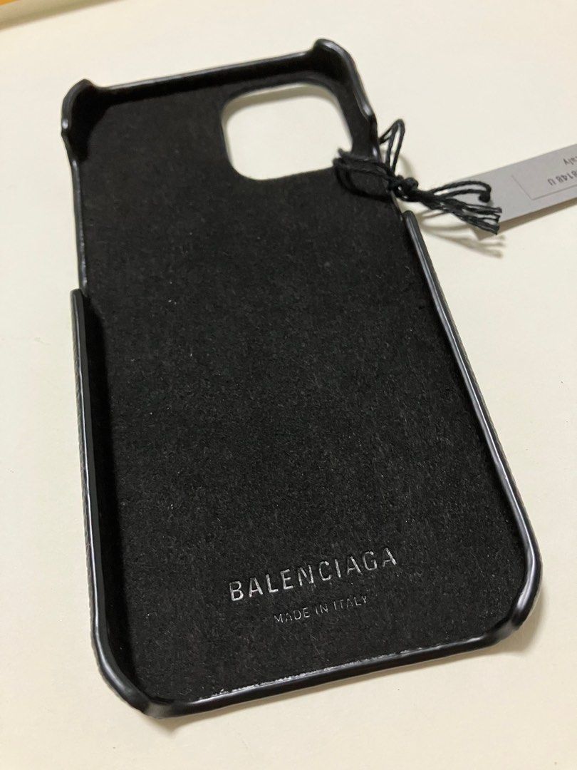 iPhone Case (Category: Cases & Sleeves) located in Singapore. Submitted by ahjibalang (Listing ID 1395129071, Image 2). Description: - Balenciaga iPhone case for 14, Might be able to fit 15 & 13 too. Free feel to try before purchase. - Includes original box, dust bag, and tags - Features Balenciaga logo - Excellent, unused condition.
