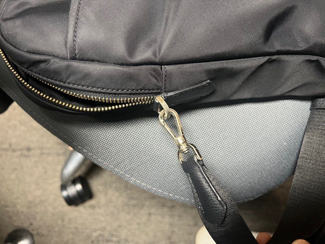 Kate Spade Black Laptop Bag (Category: Laptop Bags & Sleeves) located in Mandaluyong City. Submitted by 1hapimaki (Listing ID 1395028478, Image 2). Description: - Black laptop bag - Includes a shoulder strap and top handles - Main compartment with multiple pockets - Zipper closure - Silver-tone hardware - Made of a nylon-like material - Interior tag present.