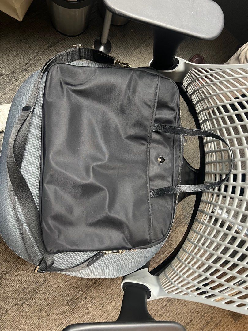 Kate Spade Black Laptop Bag (Category: Laptop Bags & Sleeves) located in Mandaluyong City. Submitted by 1hapimaki (Listing ID 1395028478, Image 3). Description: - Black laptop bag - Includes a shoulder strap and top handles - Main compartment with multiple pockets - Zipper closure - Silver-tone hardware - Made of a nylon-like material - Interior tag present.