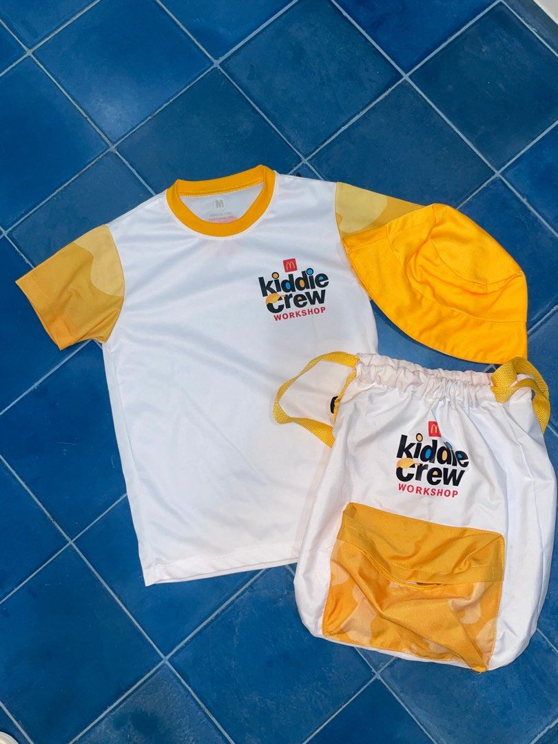 Kiddie Crew Workshop Shirt size M, Bag, and Hat Set (Category: Babies & Kids Fashion) located in Makati City. Submitted by jestangan (Listing ID 1395157195, Image 1). Description: - Kiddie Crew Workshop Set - Includes: - White shirt with yellow collar and short sleeves size MEDIUM -worn by my daughter 5 years old but fitting is lose - Matching yellow hat - Drawstring bag with yellow pocket - Features the Kiddie Crew Workshop logo on all items - P