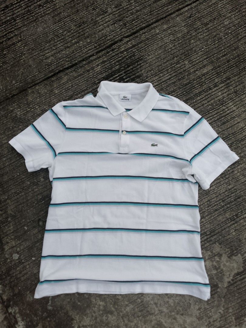 Lacoste Striped Polo Shirt (Category: Tshirts & Polo Shirts ) located in Antipolo. Submitted by thriftingmob (Listing ID 1395064631, Image 1). Description: - Lacoste polo shirt - White with vertical teal and navy stripes - Classic polo collar - Short sleeves - Lacoste logo on chest - Button-up placket - Striped detailing on sleeves - Comfortable fabric -Size 5.
