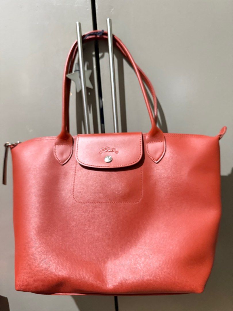 Longchamp Le Pliage Tote Bag From HKIA (Category: Luxury Bags & Wallets) located in Paranaque City. Submitted by jb38388 (Listing ID 1394986421, Image 2). Description: Longchamp “Le Pliage City” tote bag in PVC and leather Flat shoulder straps Center flap with snap/zip top closures Lining: polyester Approx. 10.4”H x 11”W x 6.1”D Bought in Hongkong Intl Airport Brand longchamp Color terracotta Highlights cognac brown calf leather smooth grain two 