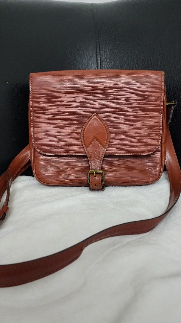 Louis Vuitton Epi Leather Shoulder Bag (Category: Luxury Bags & Wallets) located in Marilao. Submitted by curleylux (Listing ID 1394973153, Image 1). Description: - Vintage Louis Vuitton shoulder bag - Epi Leather in brown - Flap closure with buckle - Long shoulder strap - Leather interior - Interior logo stamp.