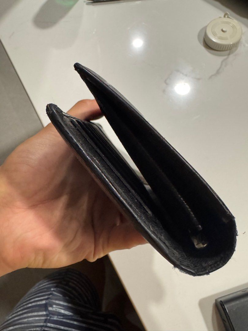 Louis Vuitton Epi Leather Wallet (Category: Luxury Bags & Wallets) located in Mexico. Submitted by beyond.luxury (Listing ID 1395147829, Image 2). Description: - Authentic Louis Vuitton wallet - Made in France - Black exterior with LV logo - Interior features card slots and a zippered compartment - Initials "M.F.M" visible inside.