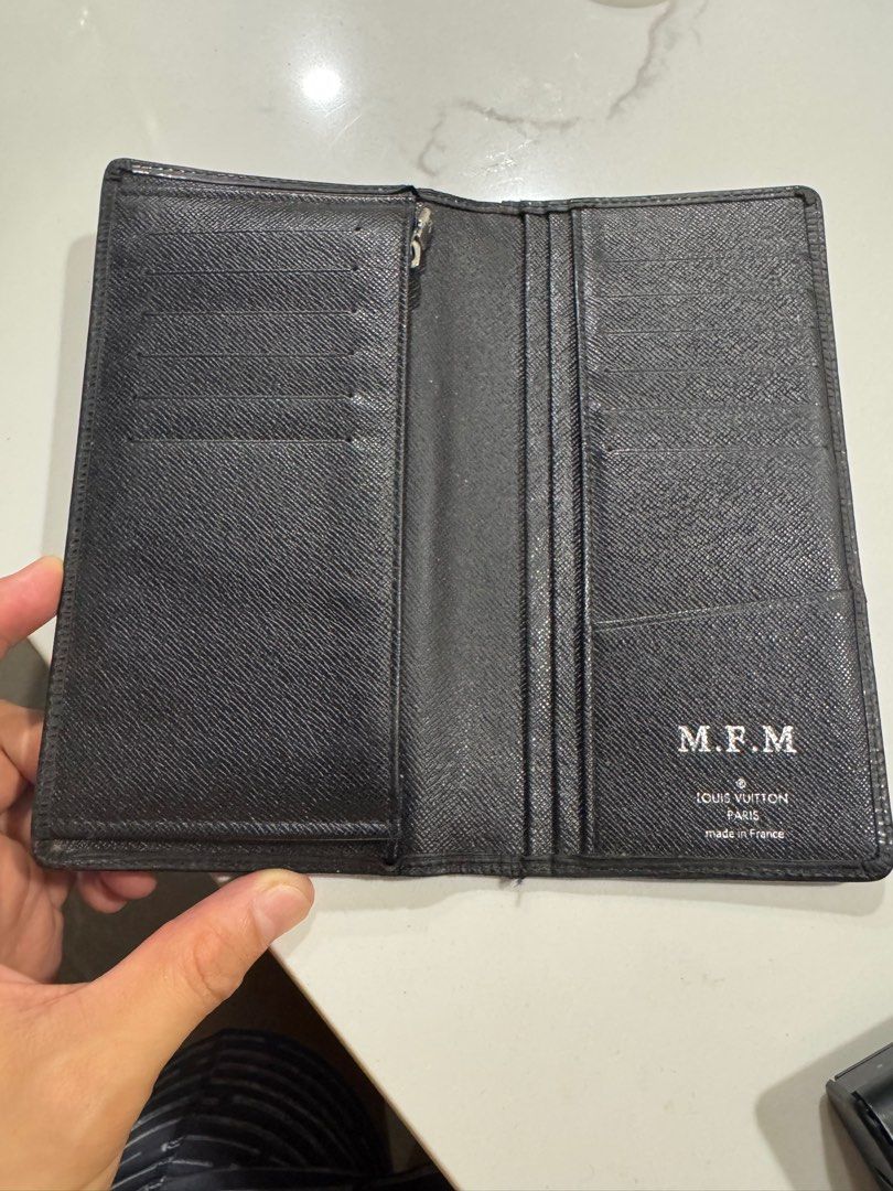 Louis Vuitton Epi Leather Wallet (Category: Luxury Bags & Wallets) located in Mexico. Submitted by beyond.luxury (Listing ID 1395147829, Image 3). Description: - Authentic Louis Vuitton wallet - Made in France - Black exterior with LV logo - Interior features card slots and a zippered compartment - Initials "M.F.M" visible inside.