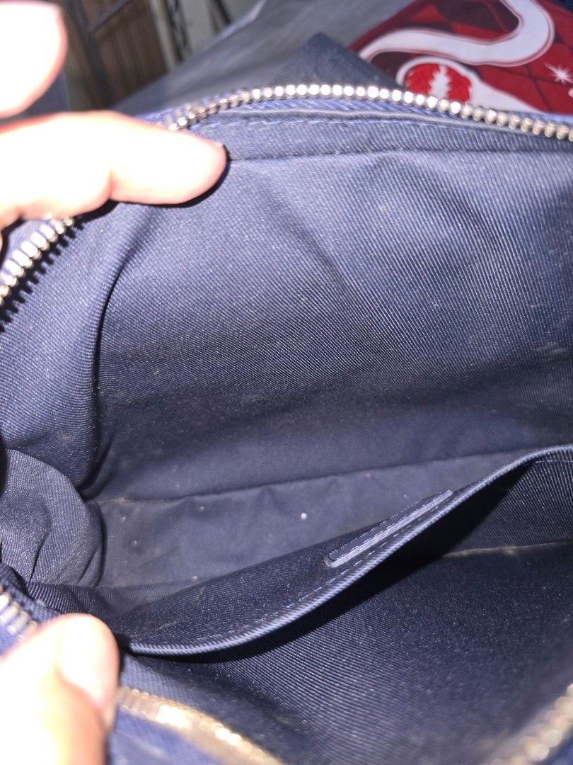 Louis Vuitton Sling Bag (Category: Luxury Bags & Wallets) located in Pasay City. Submitted by piaaaaa_952 (Listing ID 1395062000, Image 3). Description: - Navy blue sling bag - Features the Louis Vuitton logo - Main compartment and interior pockets - Zipper closure - Logo-printed strap - Navy blue interior lining.