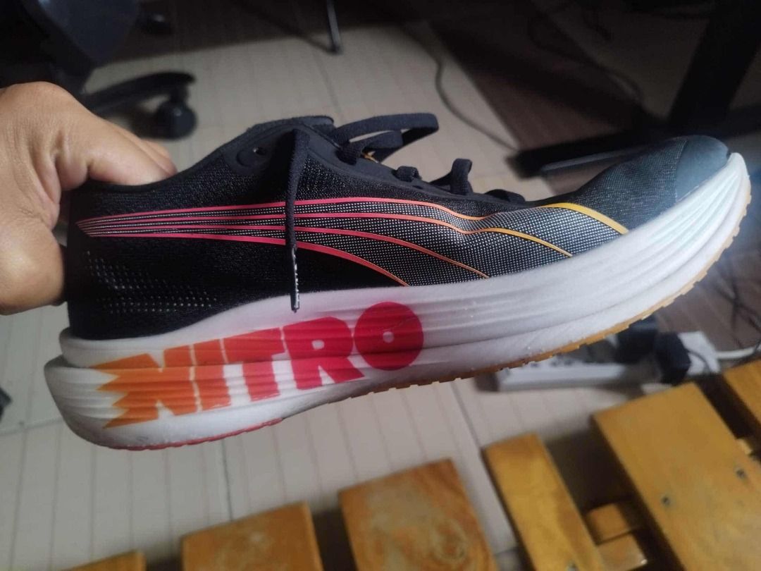 PUMA Nitro Deviate 2 ELITE (US Mens Size 12) (Category: Sneakers) located in Paranaque City. Submitted by shop.sports (Listing ID 1395076145, Image 3). Description: - PUMA Nitro Deviate 2 Elite (US Mens Size 12) - Color: Black - Midsole: White with NITRO branding and PWRPLATE technology - Outsole: PUMAGRIP for superior grip - Upper: Black with pink and orange accents - Sole details: Orange and red accents.