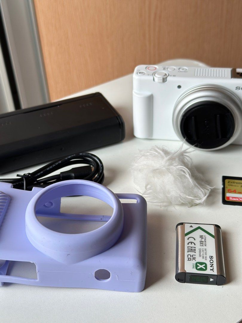 Sony ZV-1F Digital Camera (Category: Cameras) located in Makati City. Submitted by nessaolx (Listing ID 1394990307, Image 1). Description: - Sony ZV-1F digital camera (white) - Features a flip-out screen Inclusions: - 1 Battery - charger for 3 batteries w/ type-c cord - 64gig SD card - purple silicone case - mic furry wind muff * No box.