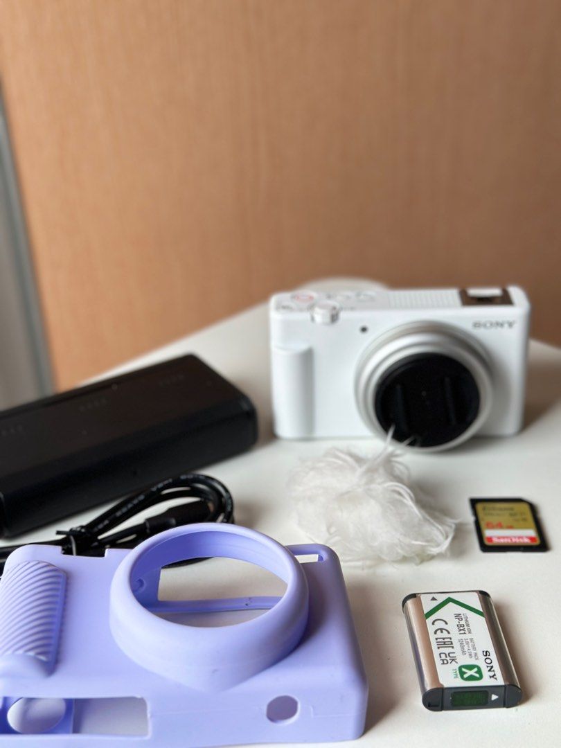 Sony ZV-1F Digital Camera (Category: Cameras) located in Makati City. Submitted by nessaolx (Listing ID 1394990307, Image 3). Description: - Sony ZV-1F digital camera (white) - Features a flip-out screen Inclusions: - 1 Battery - charger for 3 batteries w/ type-c cord - 64gig SD card - purple silicone case - mic furry wind muff * No box.