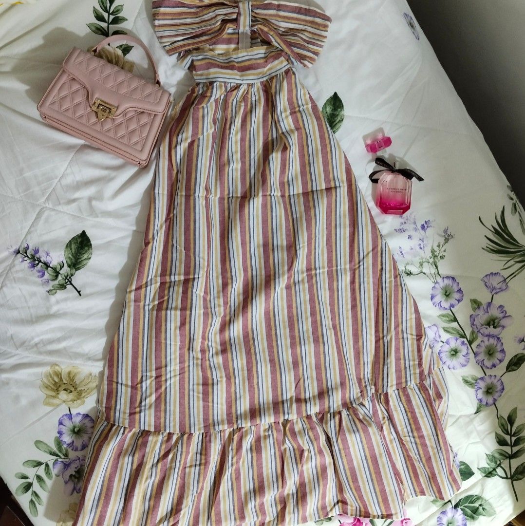 Striped Maxi Beach Summer Dress (Category: Dresses) located in Cavite. Submitted by gracieee_m (Listing ID 1395065774, Image 1). Description: - Small to Medium - Reference: 5'3 Height - Halter neck maxi dress - Cut-out design - Eye-catching red, yellow, and blue striped pattern - Lightweight fabric, ideal for warm weather - Elegant tiered ruffle hem - Floor-length.