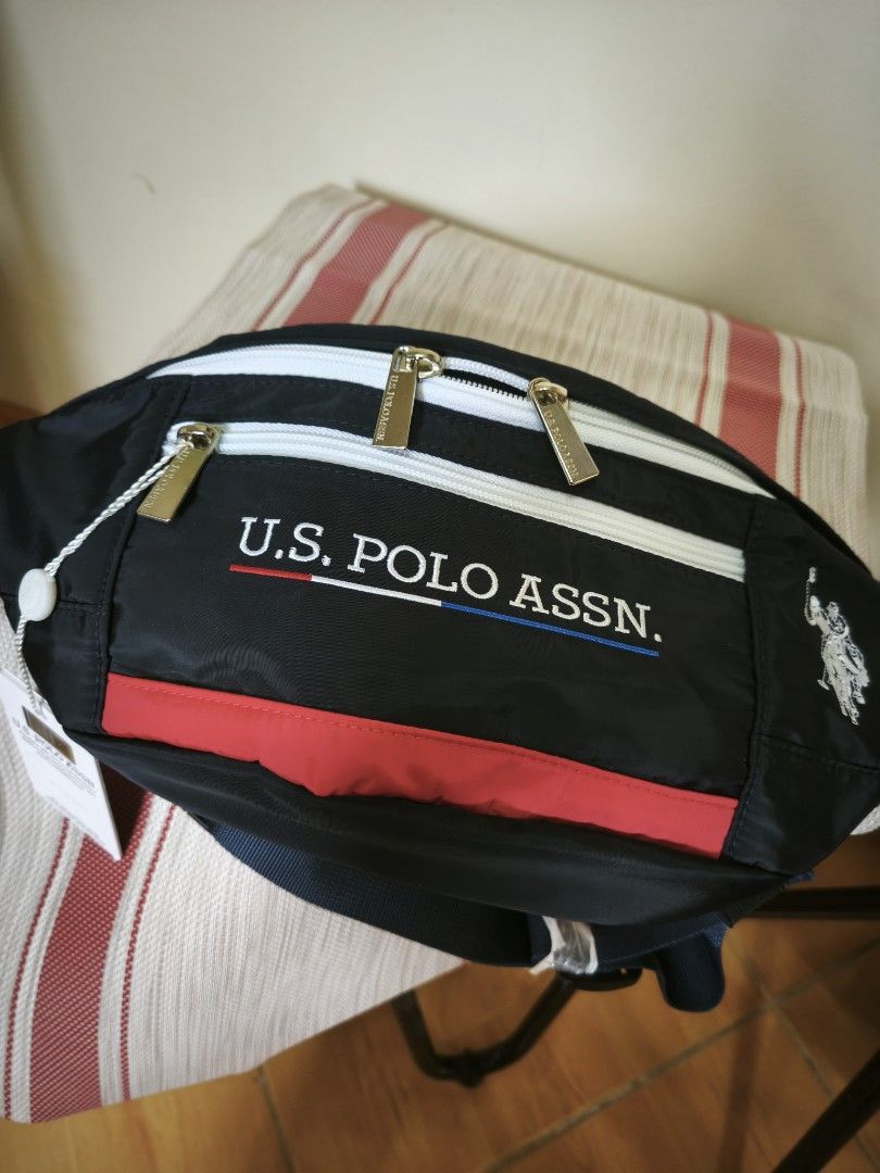 U.S. Polo Assn. Fanny Pack (Category: Other Sports Equipment and Supplies) located in Legazpi City. Submitted by fhlorms (Listing ID 1395040499, Image 2). Description: - U.S. Polo Assn. fanny pack - Black body with white zippers and red stripe - U.S. Polo Assn. logo on front and side - Multiple compartments - Adjustable black strap - New with tags.