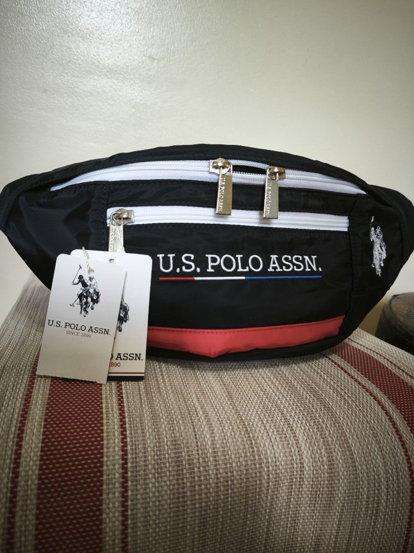 U.S. Polo Assn. Fanny Pack (Category: Other Sports Equipment and Supplies) located in Legazpi City. Submitted by fhlorms (Listing ID 1395040499, Image 3). Description: - U.S. Polo Assn. fanny pack - Black body with white zippers and red stripe - U.S. Polo Assn. logo on front and side - Multiple compartments - Adjustable black strap - New with tags.
