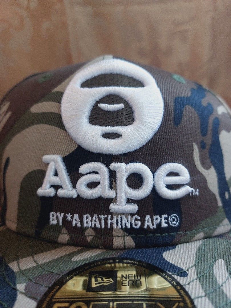 Aape X New Era Camo Hat (Category: Luxury Accessories) located in Muntinlupa City. Submitted by sakurambo_des (Listing ID 1394940294, Image 2). Description: Auth.Aape X New Era Camouflage Fitted Hat 59fifty 7⅛ /56.8cm stickers intact in excellent condition..
