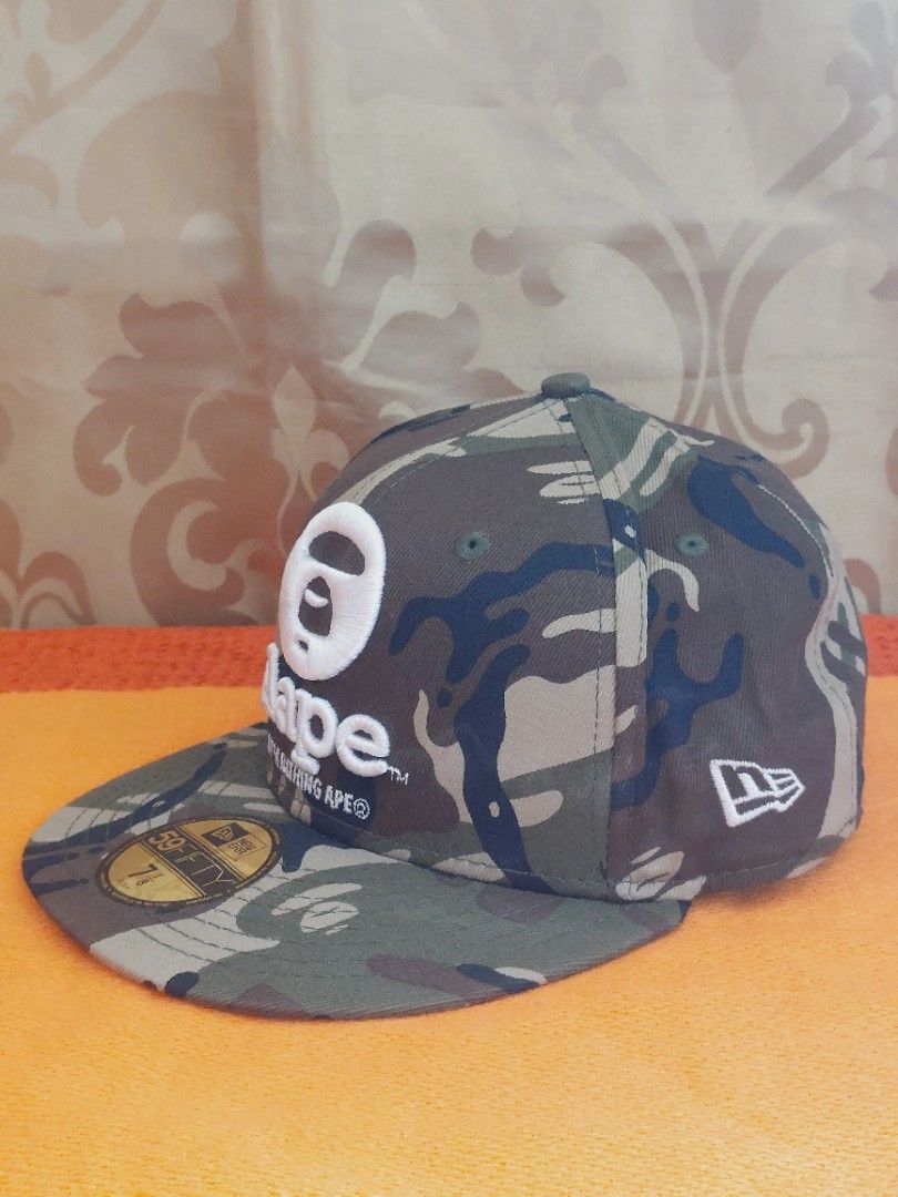 Aape X New Era Camo Hat (Category: Luxury Accessories) located in Muntinlupa City. Submitted by sakurambo_des (Listing ID 1394940294, Image 3). Description: Auth.Aape X New Era Camouflage Fitted Hat 59fifty 7⅛ /56.8cm stickers intact in excellent condition..