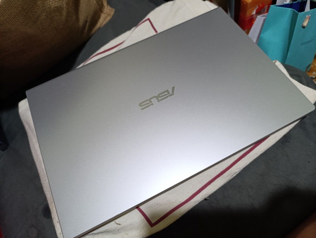 ASUS Laptop (Category: Laptops & Notebooks) located in Imus. Submitted by genramos82 (Listing ID 1395172754, Image 2). Description: - ASUS laptop with a silver finish - Full keyboard and touchpad - Black screen - NVIDIA logo sticker - ASUS logo on the back.