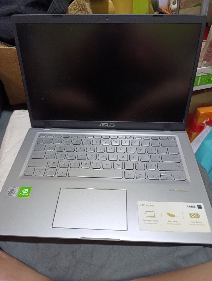 ASUS Laptop (Category: Laptops & Notebooks) located in Imus. Submitted by genramos82 (Listing ID 1395172754, Image 1). Description: - ASUS laptop with a silver finish - Full keyboard and touchpad - Black screen - NVIDIA logo sticker - ASUS logo on the back.