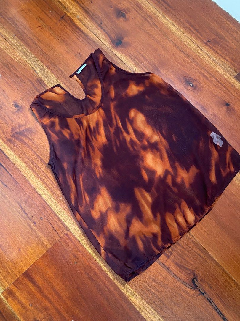 Brown Red Print Sheer Sleeveless Top (Category: Sleeveless) located in Angeles City. Submitted by hellobeev (Listing ID 1395199002, Image 1). Description: - Sleeveless sheer top - Unique brown and orange pattern - Round neckline with keyhole - Lightweight, flowy fabric - Versatile style - No button - 20 in width , 25 in length.