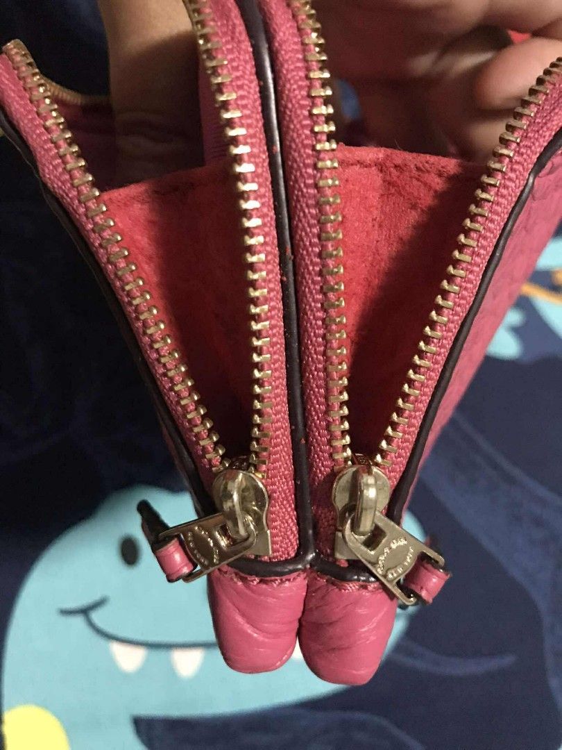 Coach Pink Wristlet (Category: Luxury Bags & Wallets) located in Tanza. Submitted by maryannrod99102 (Listing ID 1395171697, Image 3). Description: - Authentic Coach wristlet - Vibrant pink color - Textured leather exterior - Two zippered compartments - Interior card slots - Matching pink fabric lining - Gold-toned zippers - Includes wrist strap - Features a Coach tag -colors may vary due to lighting -issue nabakbak na ung leather sa loob sa gili
