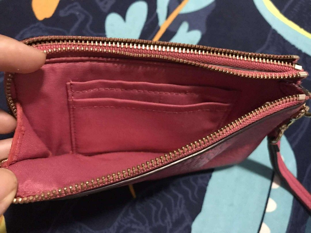 Coach Pink Wristlet (Category: Luxury Bags & Wallets) located in Tanza. Submitted by maryannrod99102 (Listing ID 1395171697, Image 2). Description: - Authentic Coach wristlet - Vibrant pink color - Textured leather exterior - Two zippered compartments - Interior card slots - Matching pink fabric lining - Gold-toned zippers - Includes wrist strap - Features a Coach tag -colors may vary due to lighting -issue nabakbak na ung leather sa loob sa gili