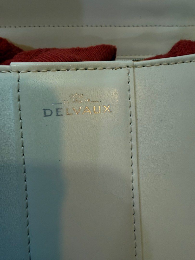 Delvaux White Leather Handbag (Category: Luxury Bags & Wallets) located in Manila. Submitted by fivethousandlilies (Listing ID 1395166878, Image 3). Description: - Delvaux white leather handbag - Structured design - Top handle - Distinctive buckle closure - Interior zippered pocket - Additional compartments ✅missing long strap ✅pm for more info - Delvaux logo on interior and buckle - Branded zipper pull.