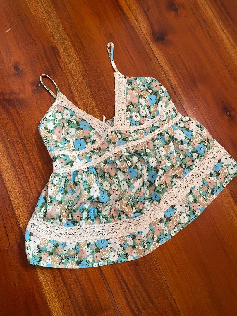 Floral Cami Top with Lace Trim (Category: Sleeveless) located in Angeles City. Submitted by hellobeev (Listing ID 1395199615, Image 1). Description: - Floral print cami top - Features blue, green, and beige flowers - Delicate adjustable spaghetti straps - Flattering shirring at the bust - Elegant lace detailing - Ideal for casual wear and summer events - 28-38 bust, 18 in length.
