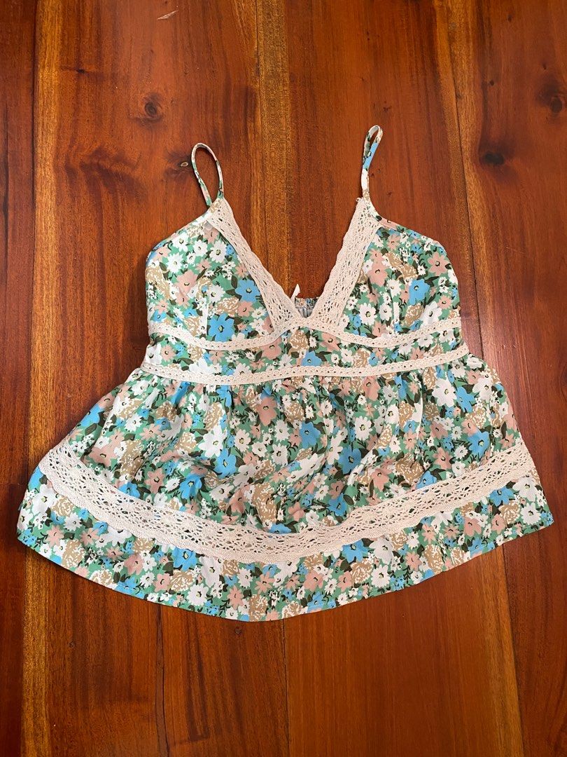 Floral Cami Top with Lace Trim (Category: Sleeveless) located in Angeles City. Submitted by hellobeev (Listing ID 1395199615, Image 2). Description: - Floral print cami top - Features blue, green, and beige flowers - Delicate adjustable spaghetti straps - Flattering shirring at the bust - Elegant lace detailing - Ideal for casual wear and summer events - 28-38 bust, 18 in length.