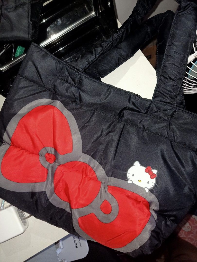 Hello Kitty Puffy Tote Bag (Category: Tote Bags) located in Bulacan. Submitted by baee__ (Listing ID 1395163090, Image 2). Description: - Kitty tote bag - Features a large red bow design - Padded handles for comfort - Red interior with Kitty patterns - Made of quilted material.