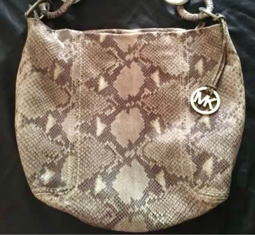 Michael Kors Snake Print Hobo Bag (Category: Shoulder Bags) located in Pasay City. Submitted by chesiel (Listing ID 1395333644, Image 3). Description: - Michael Kors hobo bag - Unique snake print design - Silver-tone hardware - Includes signature MK charm - Spacious interior - Zippered pocket inside - Michael Kors branded lining - Comfortable shoulder strap - Ideal for everyday wear.