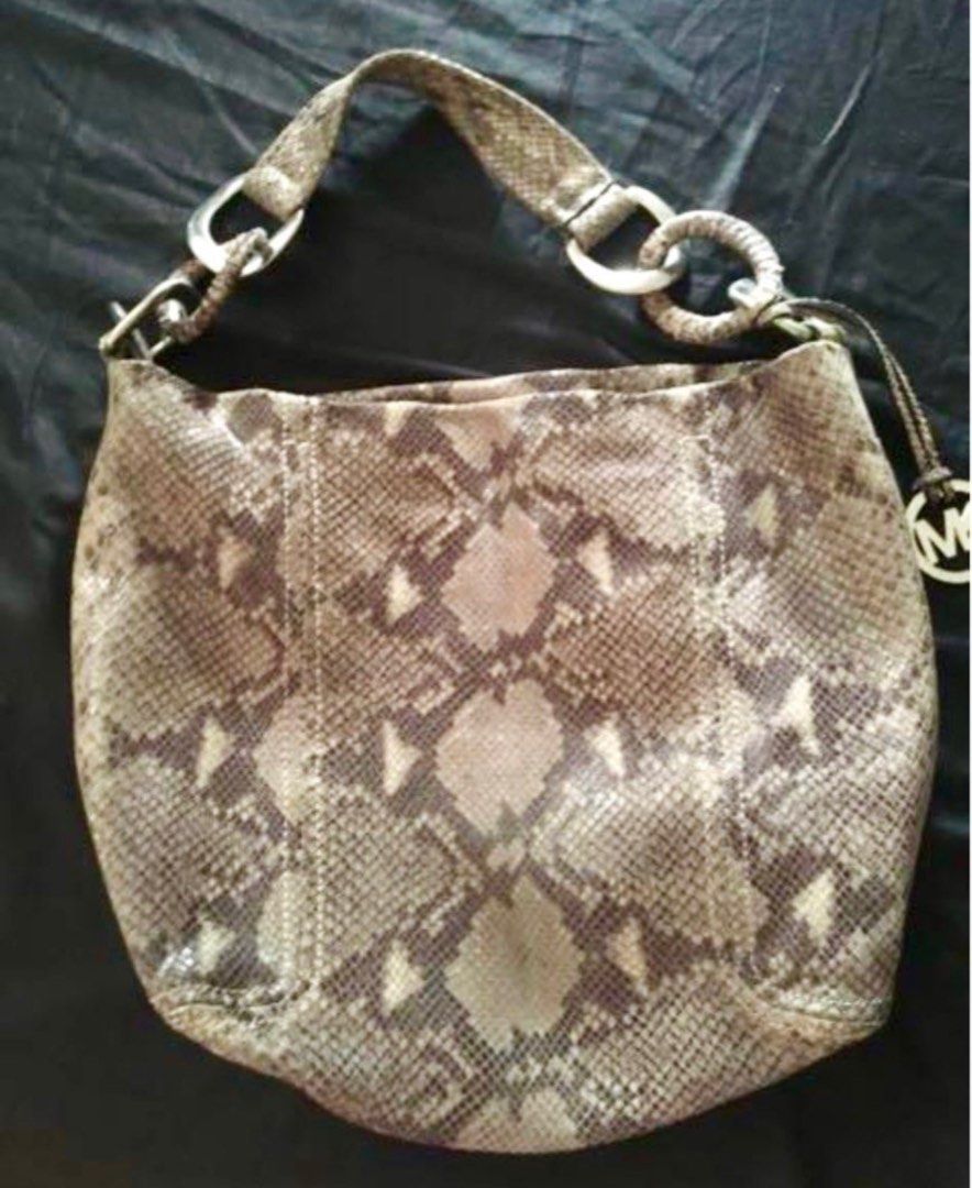 Michael Kors Snake Print Hobo Bag (Category: Shoulder Bags) located in Pasay City. Submitted by chesiel (Listing ID 1395333644, Image 2). Description: - Michael Kors hobo bag - Unique snake print design - Silver-tone hardware - Includes signature MK charm - Spacious interior - Zippered pocket inside - Michael Kors branded lining - Comfortable shoulder strap - Ideal for everyday wear.