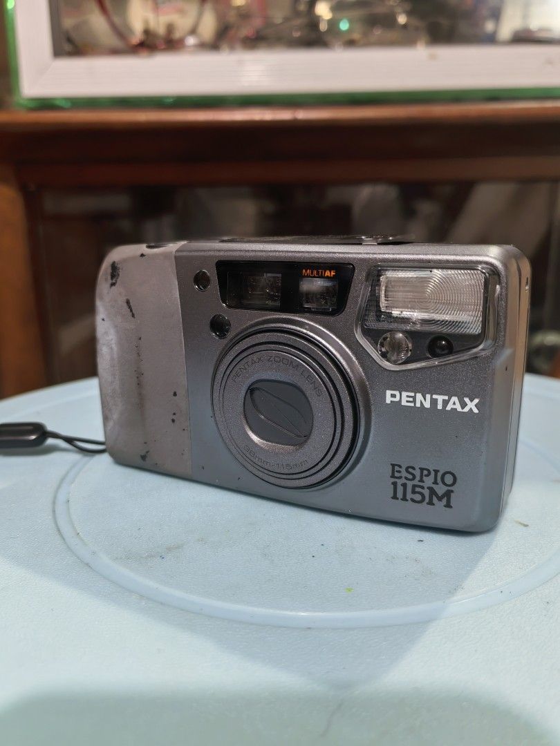 Pentax Espio 115M (Category: Cameras) located in Cebu City. Submitted by dudes_villanueva (Listing ID 1395337070, Image 2). Description: Pentax Espio 115M Note: Tested Functional. All sales final and non-refundable. Battery not included for testing and demo only. 📌 35mm compact zoom film camera. 📌This model, also known as the IQZoom 115M in the US, was introduced in 1996. 📌It features a 38-115mm zoom lens, autofocus, a built-in flash with red-