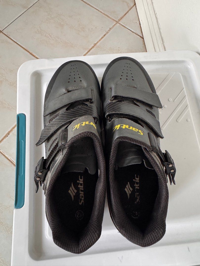 Santic Cycling Shoes Size 42 (Category: Bicycles) located in Muntinlupa City. Submitted by paorivera (Listing ID 1395163650, Image 1). Description: - Santic cycling shoes - Size 42 - Color: Grey exterior with black accents - Features yellow Santic branding - Closure: Two velcro straps and a buckle - Padded interior for comfort - Designed for cycling.