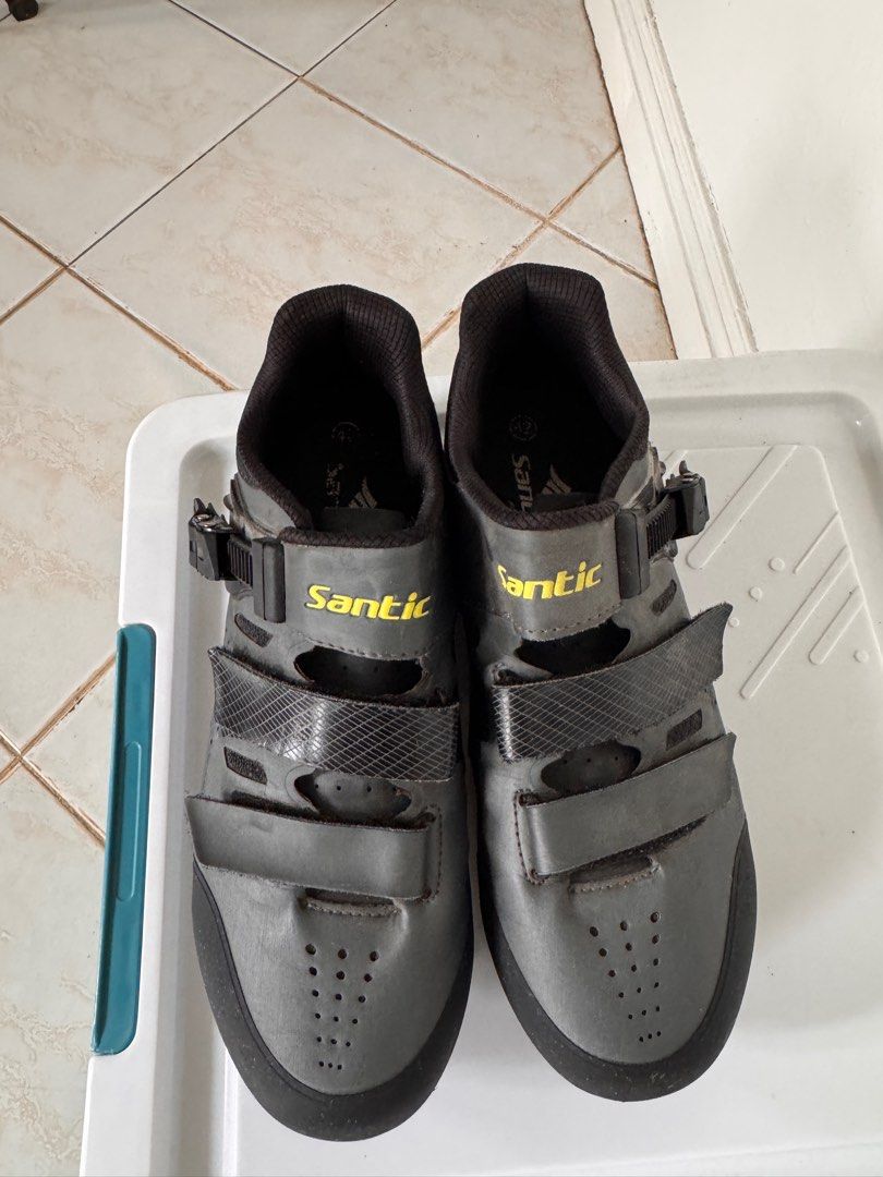 Santic Cycling Shoes Size 42 (Category: Bicycles) located in Muntinlupa City. Submitted by paorivera (Listing ID 1395163650, Image 2). Description: - Santic cycling shoes - Size 42 - Color: Grey exterior with black accents - Features yellow Santic branding - Closure: Two velcro straps and a buckle - Padded interior for comfort - Designed for cycling.