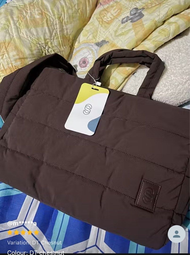 Straightforward Puffy Tote Bag Laptop Bag (Category: Tote Bags) located in Mandaluyong City. Submitted by junos.mnl (Listing ID 1395181355, Image 2). Description: - Chestnut color quilted tote bag / laptop bag - Top handles and detachable shoulder strap - Padded design - Features a logo patch - Spacious enough for a laptop and essentials - Perfect for everyday use - Bought this September 2025 and used once only - comes with plastic and white cove