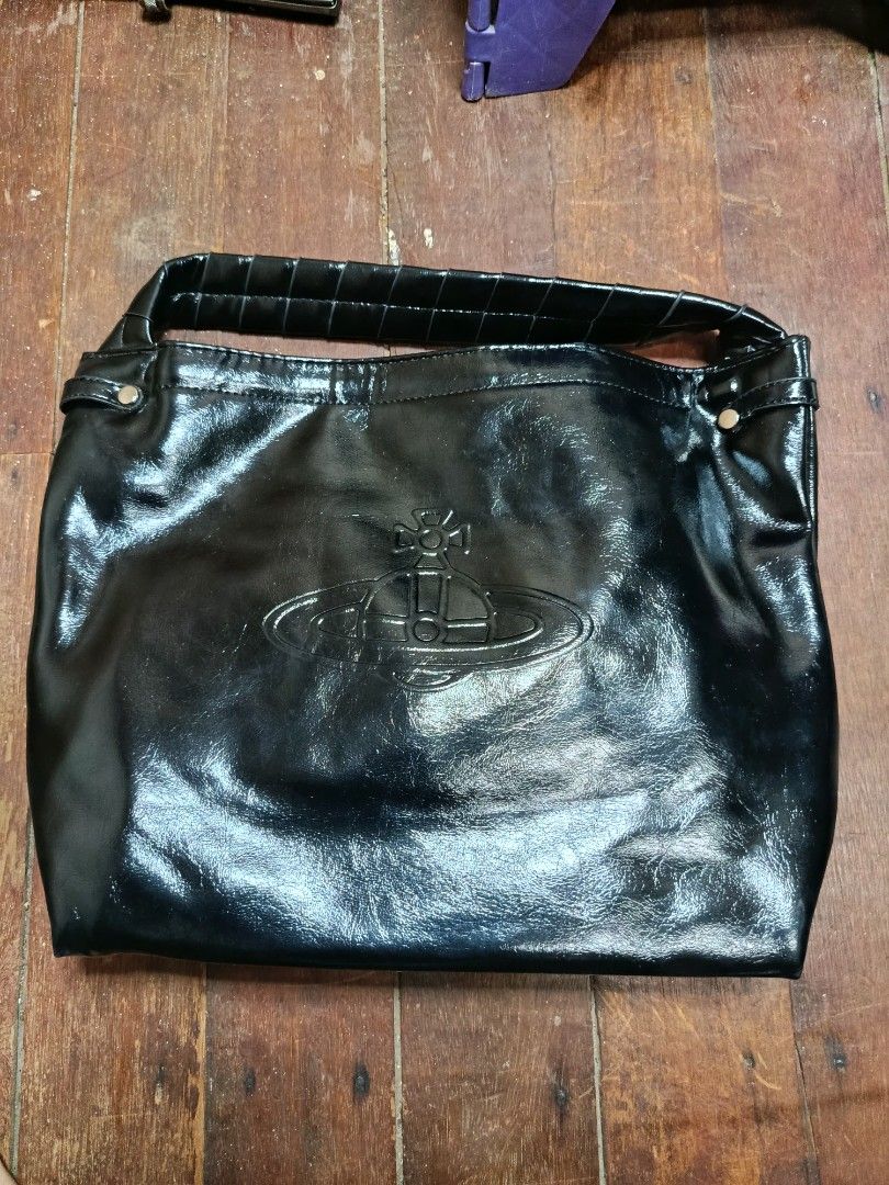 Vivienne Westwood Black Handbag (Category: Luxury Bags & Wallets) located in Manila. Submitted by daphnefinds (Listing ID 1395288855, Image 1). Description: - Black Vivienne Westwood handbag - Top handle design - Features the Vivienne Westwood logo - Glossy finish - Made in Italy - Includes a detachable strap.