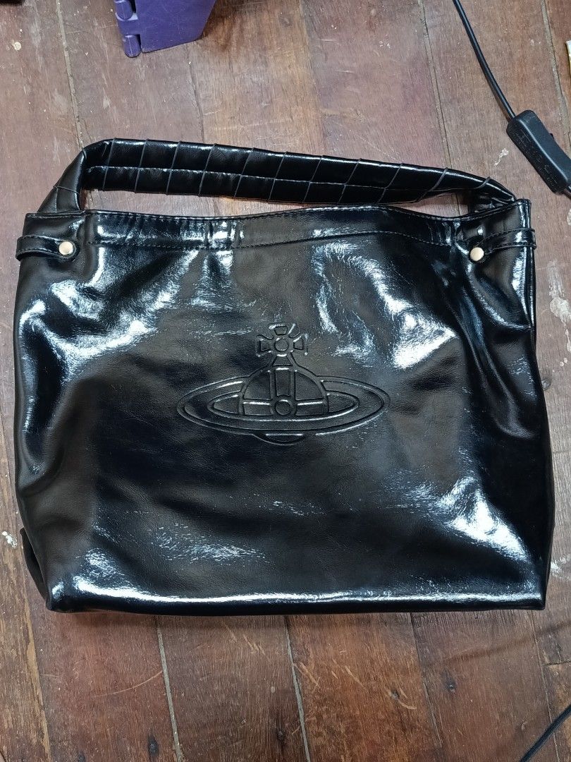 Vivienne Westwood Black Handbag (Category: Luxury Bags & Wallets) located in Manila. Submitted by daphnefinds (Listing ID 1395288855, Image 3). Description: - Black Vivienne Westwood handbag - Top handle design - Features the Vivienne Westwood logo - Glossy finish - Made in Italy - Includes a detachable strap.