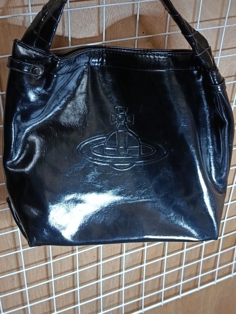Vivienne Westwood Black Handbag (Category: Luxury Bags & Wallets) located in Manila. Submitted by daphnefinds (Listing ID 1395288855, Image 2). Description: - Black Vivienne Westwood handbag - Top handle design - Features the Vivienne Westwood logo - Glossy finish - Made in Italy - Includes a detachable strap.