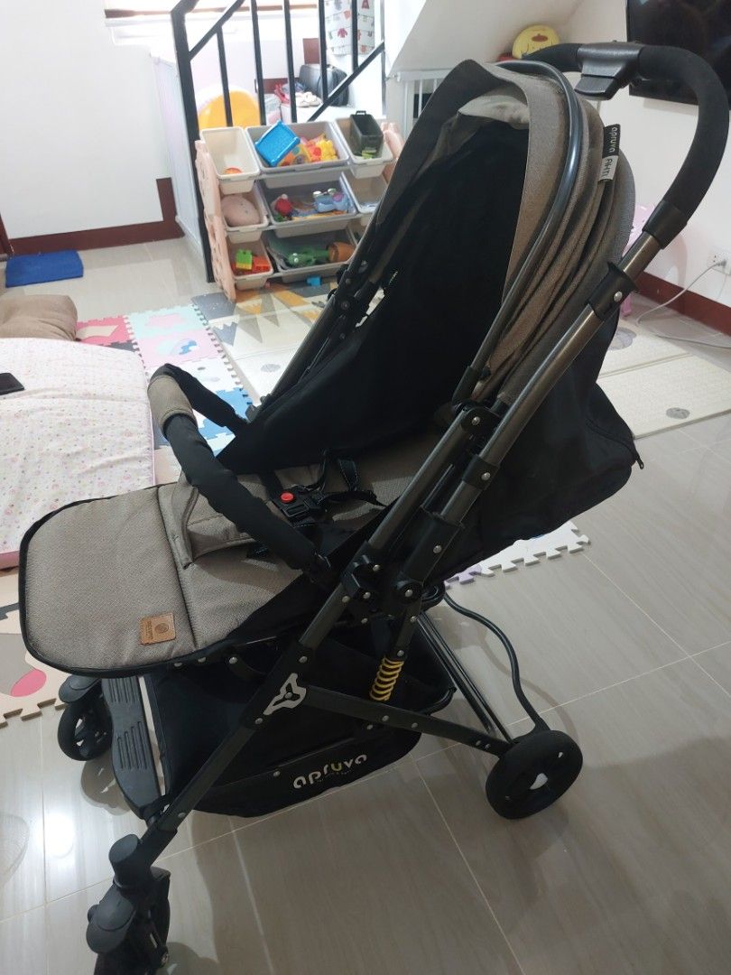 Apruva Baby Stroller (Category: Strollers) located in Manila. Submitted by mini_closet_shoppe (Listing ID 1395504940, Image 2). Description: - baby stroller - Sleek design with sunshade - Comfortable seat - Foldable for easy storage and transport - Neutral color scheme - Safety harness included - Suitable for everyday use.