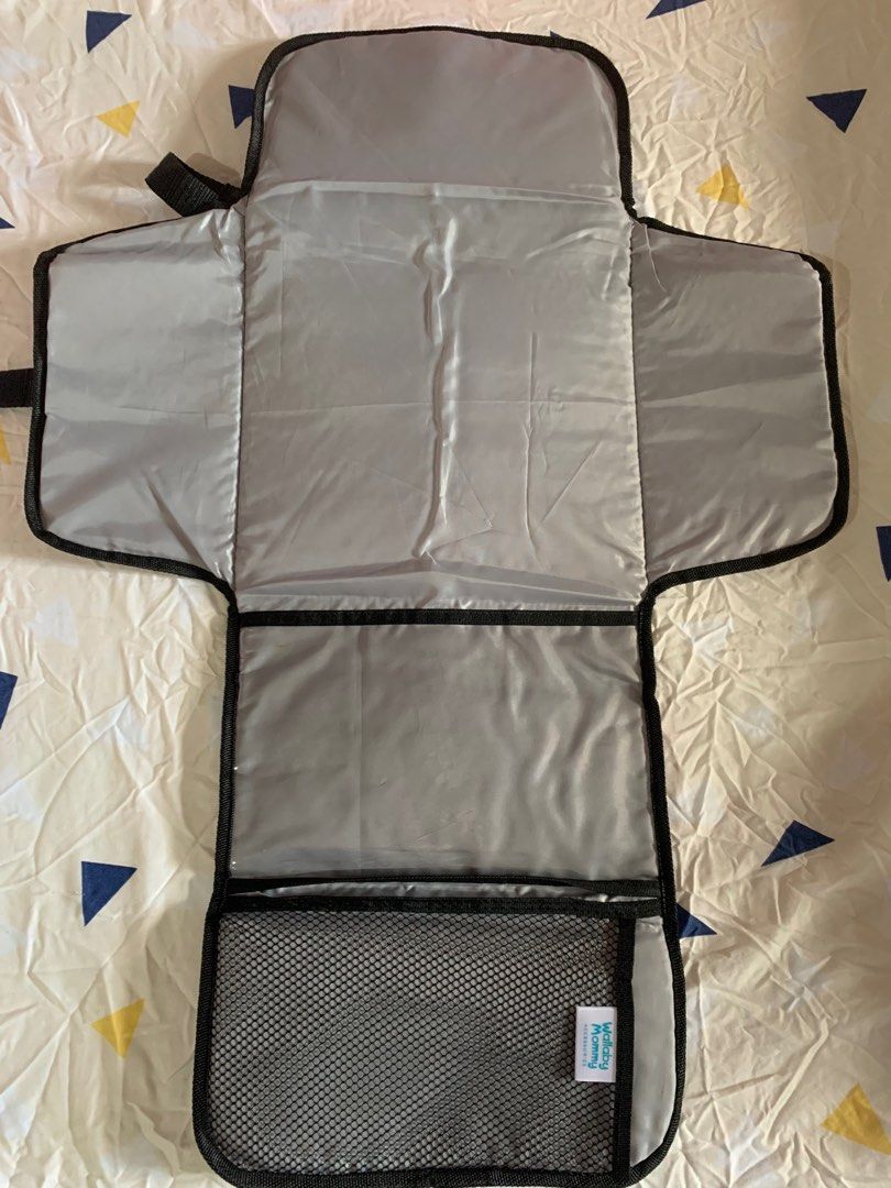 Baby’s PortableChanging Pad (Category: Changing Mats & Accessories) located in Paranaque City. Submitted by elainegrace22 (Listing ID 1395519253, Image 3). Description: - Stylish pink camouflage design - Unfolds to a padded changing surface - Includes a pocket and a mesh compartment for cleaning essentials - Features a zippered pocket - Comes with a strap for easy carrying - Folds up and secures with a buckle - Interior color: Light grey.