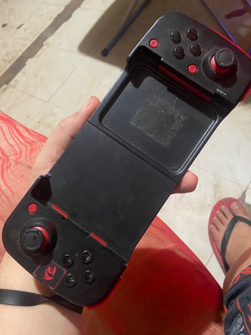 BSP-D3 Mobile Game Controller (Category: Controllers) located in Taguig. Submitted by billpogi23 (Listing ID 1395480905, Image 2). Description: BSP-D3 mobile game controller. It features a black and red design with multiple buttons and a slot for a mobile device. The controller has a working voltage of DC3.7V and an input of DC5V 500mA. It is made in China. The duration is greater than 20 hours, and the sleep current is less than 5uA. Unit only n