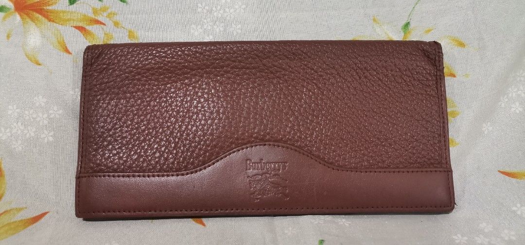 BURBERRYS Brown Leather Long Wallet (Category: Luxury Bags & Wallets) located in Baguio. Submitted by blossombeauty.chicfinds23 (Listing ID 1395418360, Image 2). Description: - Genuine Burberry wallet - Rich brown textured leather - Subtle Burberry logo embossing - Classic Burberry check interior lining - Multiple compartments for cards and cash - Stylish and functional design.