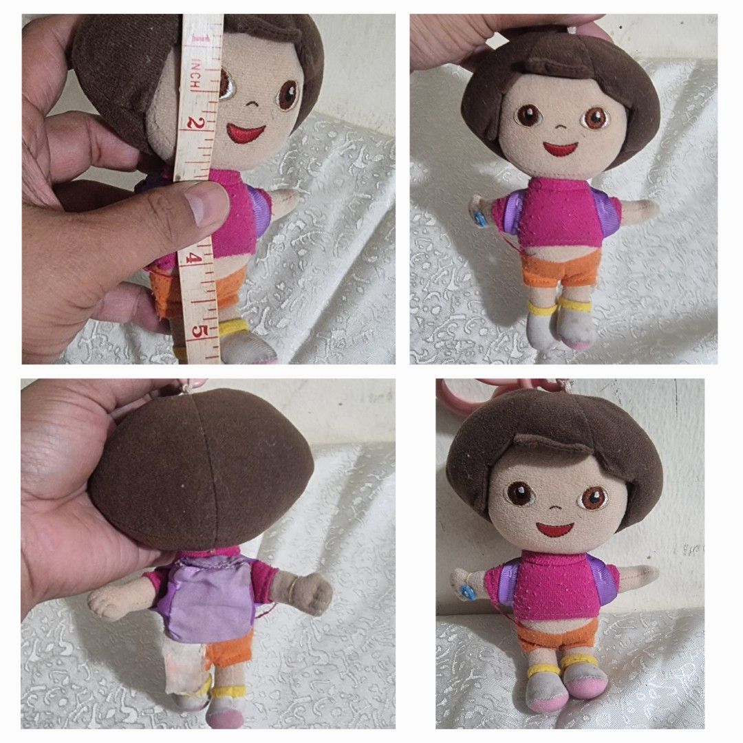 Dora the Explorer Plush Doll (Category: Plushies & Soft Toys) located in Marikina City. Submitted by andreah2931 (Listing ID 1395478671, Image 1). Description: - Adorable Dora the Explorer plush doll - Features Dora in her classic outfit: pink shirt, orange shorts, and purple backpack - Doll has brown hair and friendly eyes - Approximately 5 inches tall - Great for any Dora fan!.